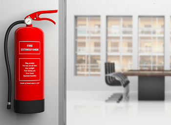 Fire extinguisher hung on a wall outside of a meeting room