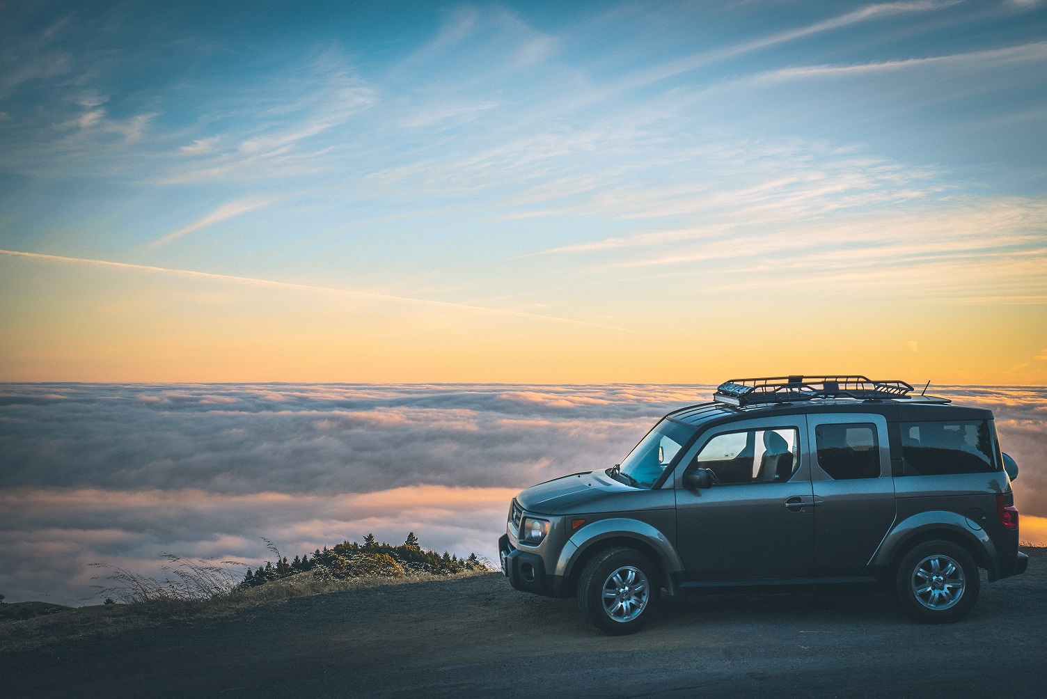 SUV on mountain at sunset