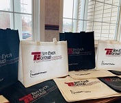 Reusable bags with the Ten Eyck Group logo on them