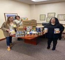 Ten Eyck Team members with canned food